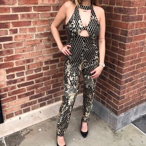 L’ATISTE Black and Gold jumpsuit
